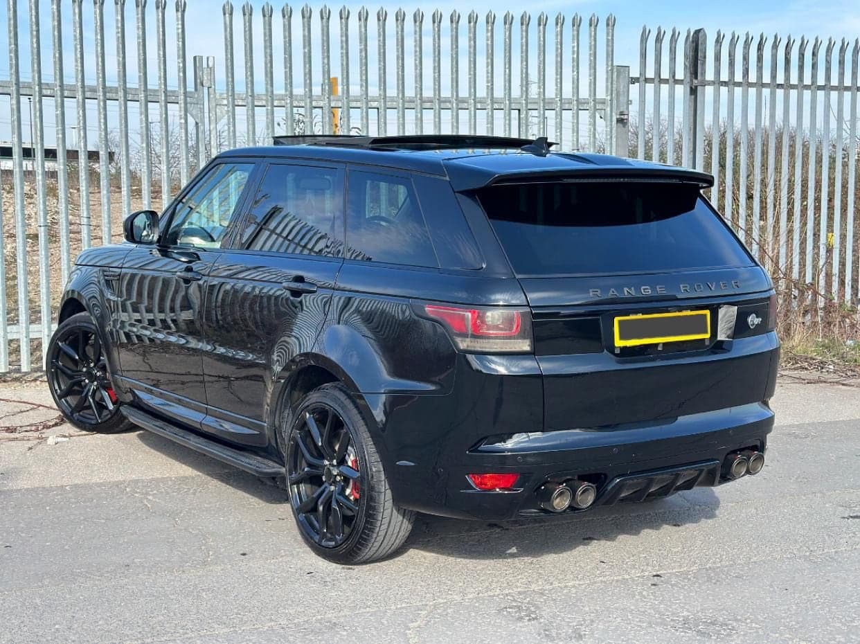 Black Range Rover Sport with dark tinted rear windows
