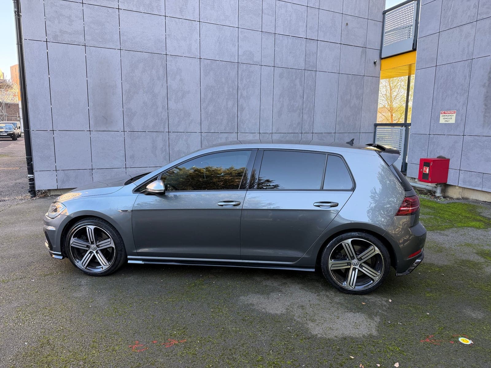 Grey VW Golf R showing tinted rear side windows alongside clear front glass